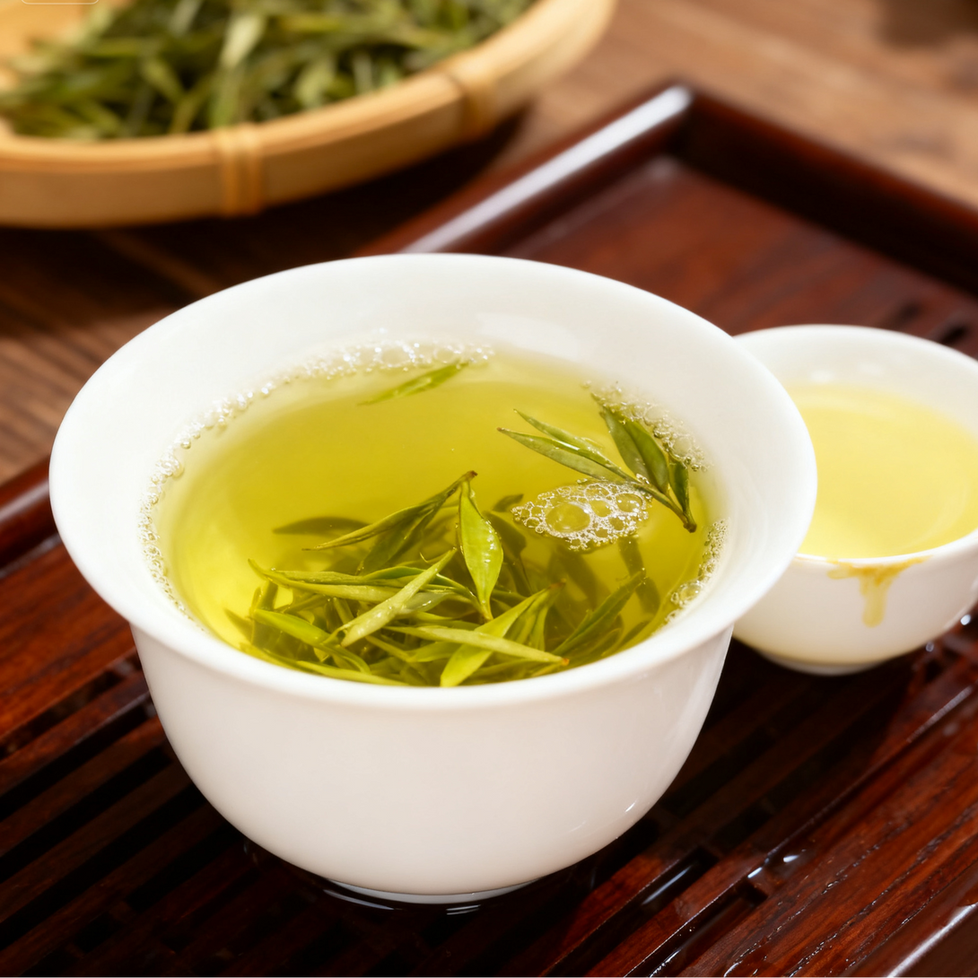 Freshly brewed Chinese green tea with tender tea leaves in white porcelain cup on wooden tray.
