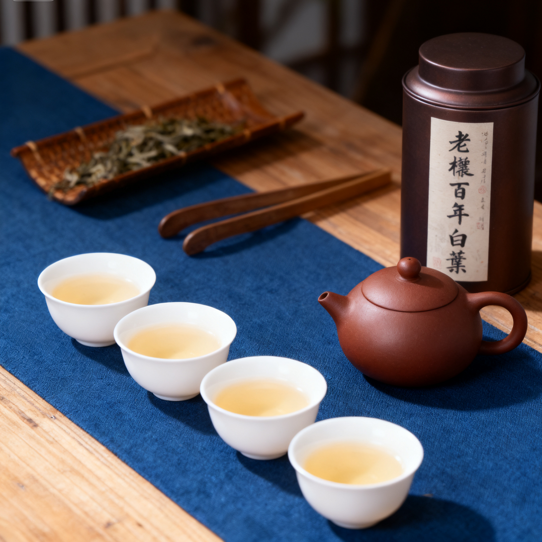 Traditional tea set with four teacups, a teapot, and a tea canister on a blue cloth