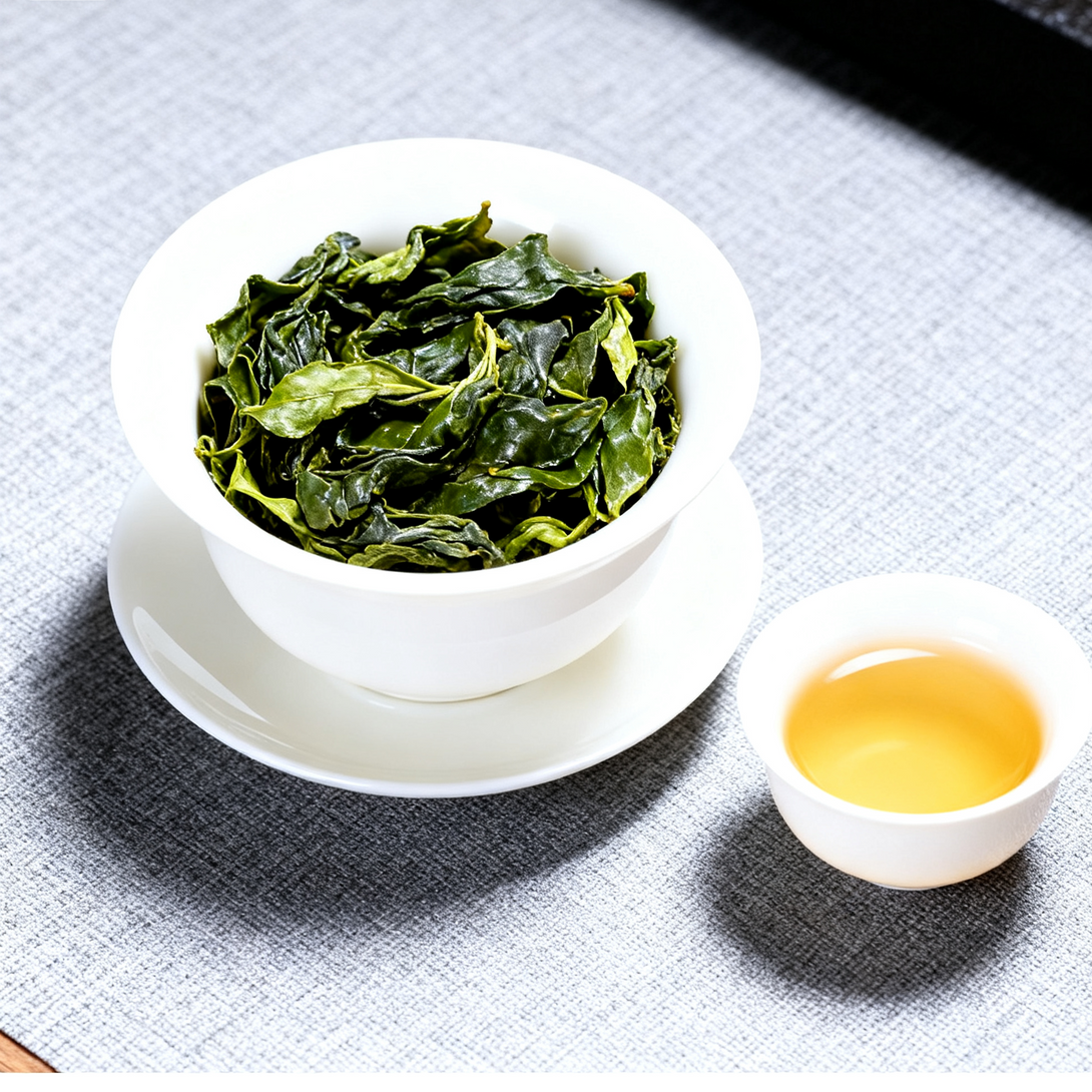 Bowl of brewed green tea leaves with cup of golden tea liquor